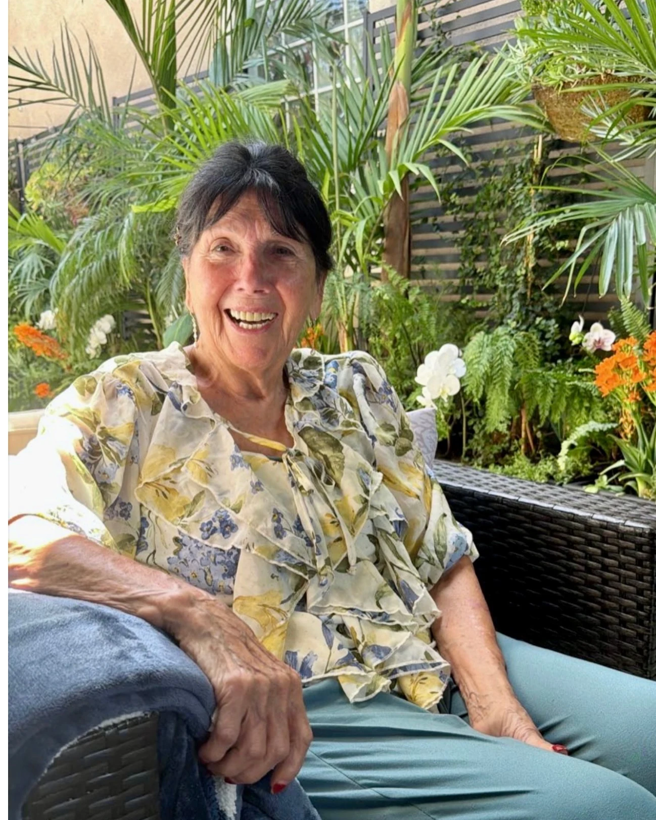 The mother whose spirit inspired Forever Young Home Care, laughing on her patio